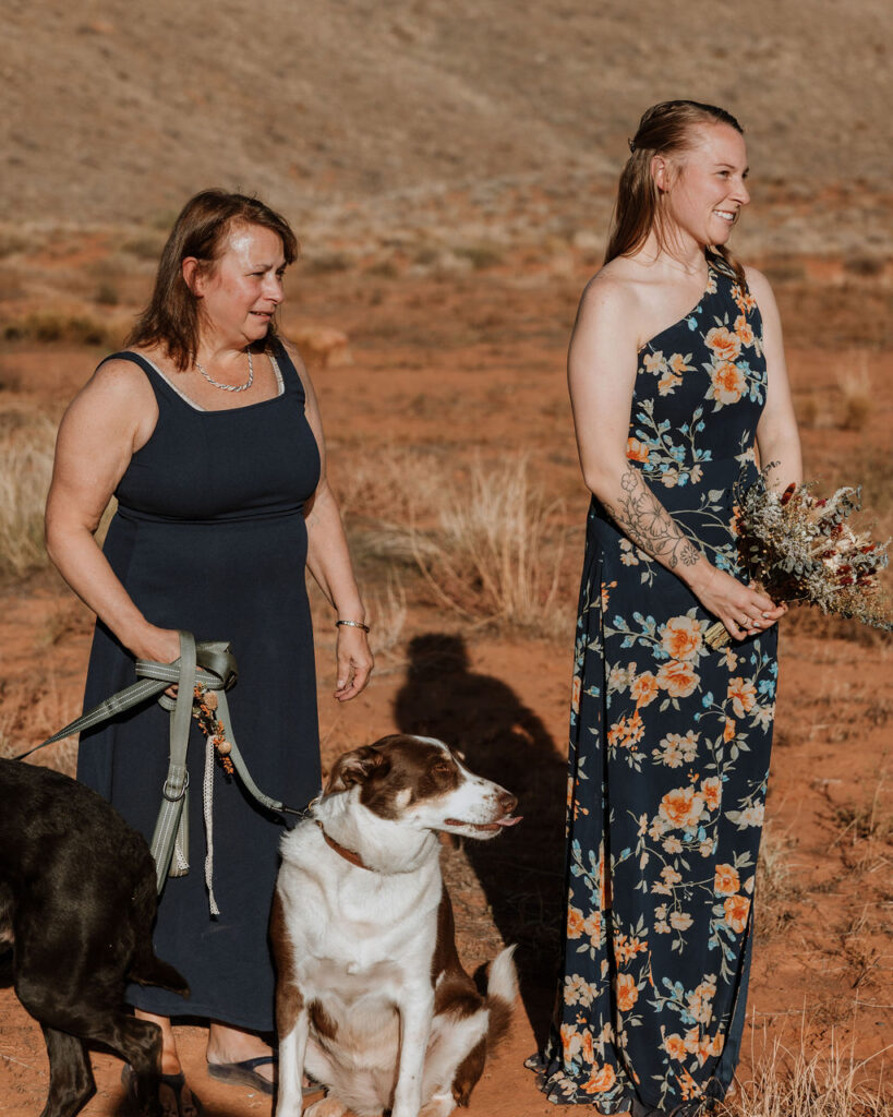 wedding party holds dogs at Moab elopement