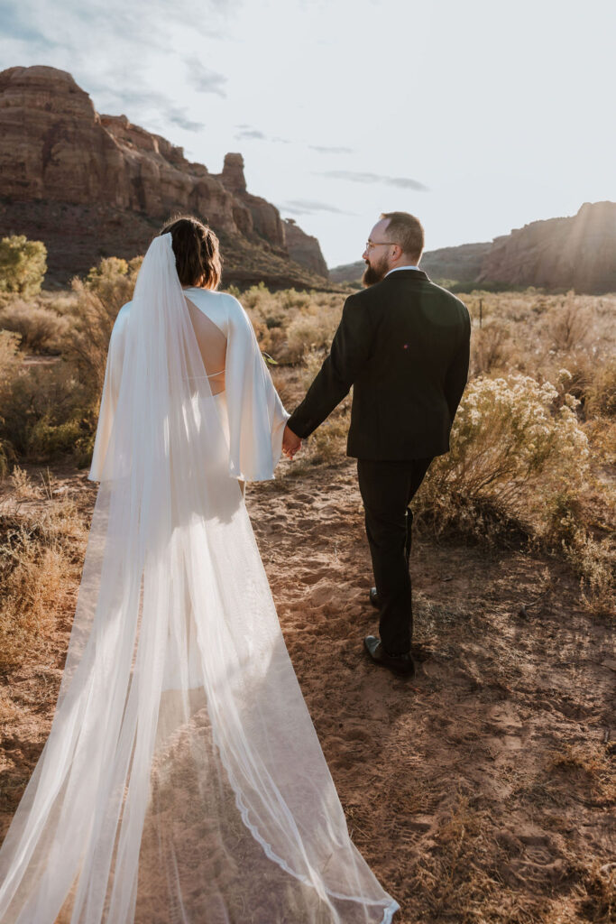 couple walks along Moab desert at The Red Earth Venue