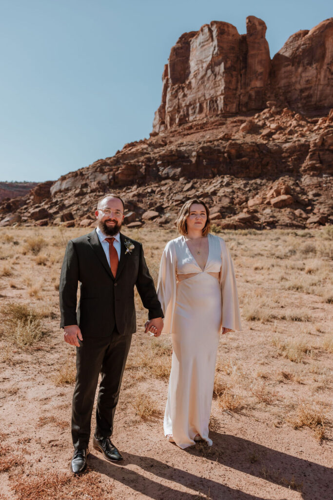 couple walks along Moab desert at The Red Earth Venue