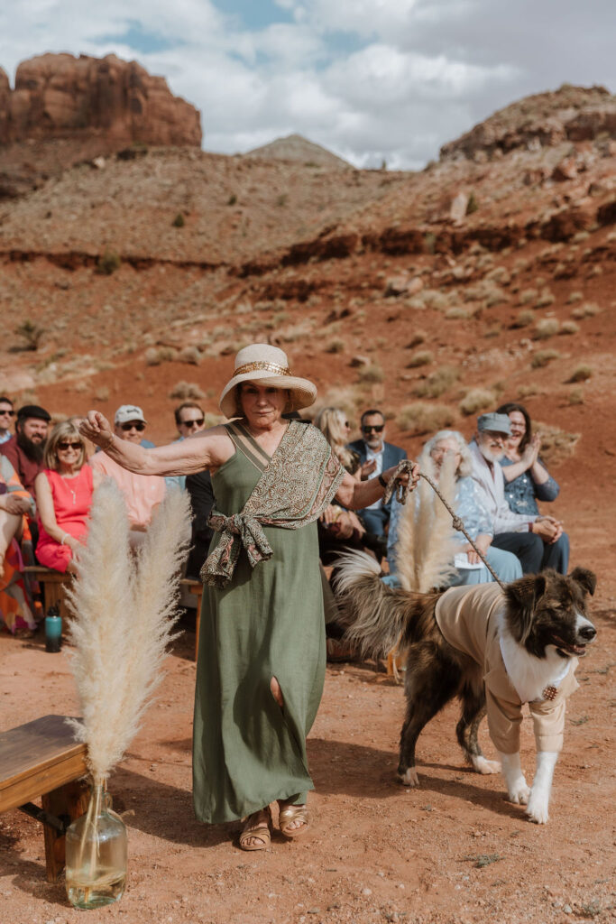 mother of bride walks dog down the aisle