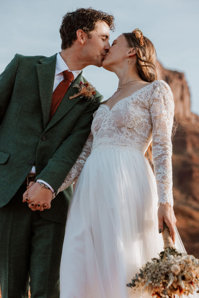 Couple kisses during couples photos at Castle Valley Utah Elopement