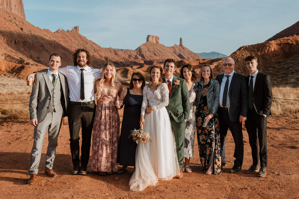 Couple poses with their friends and family at their Castle Valley Utah Elopement