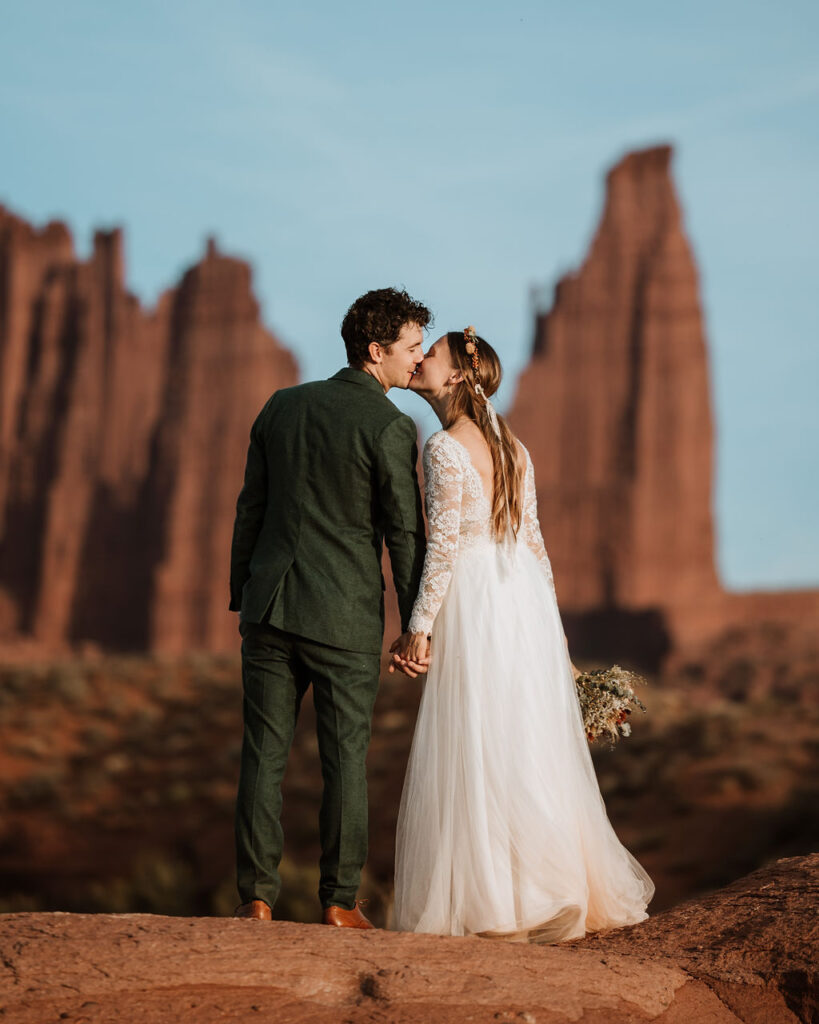 couple kisses during couples photos at Castle Valley Utah Elopement