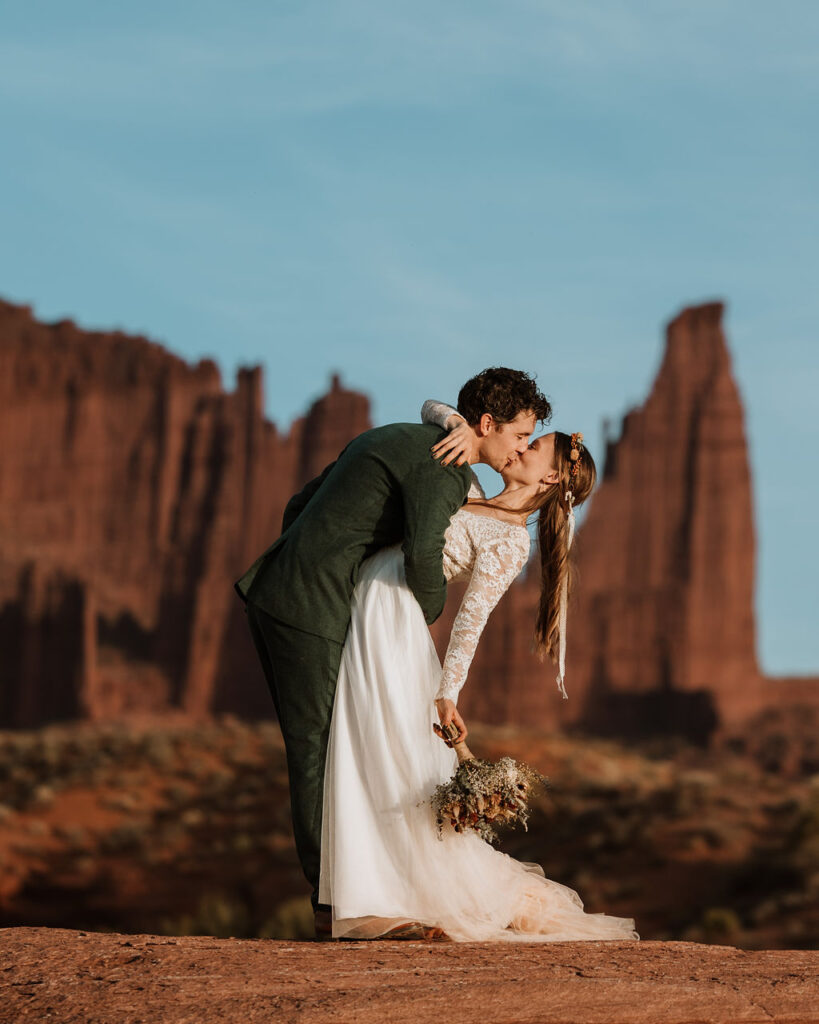 couple kisses during couples photos at Castle Valley Utah Elopement