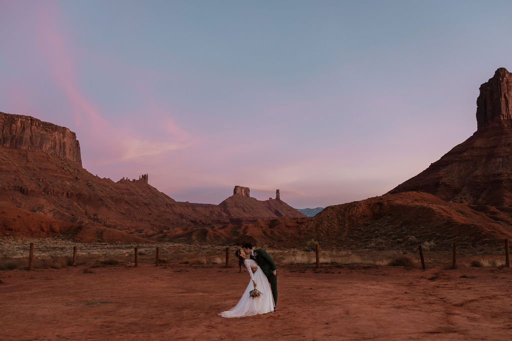 A couple kisses at Sunset during their Castle Valley Utah Elopement