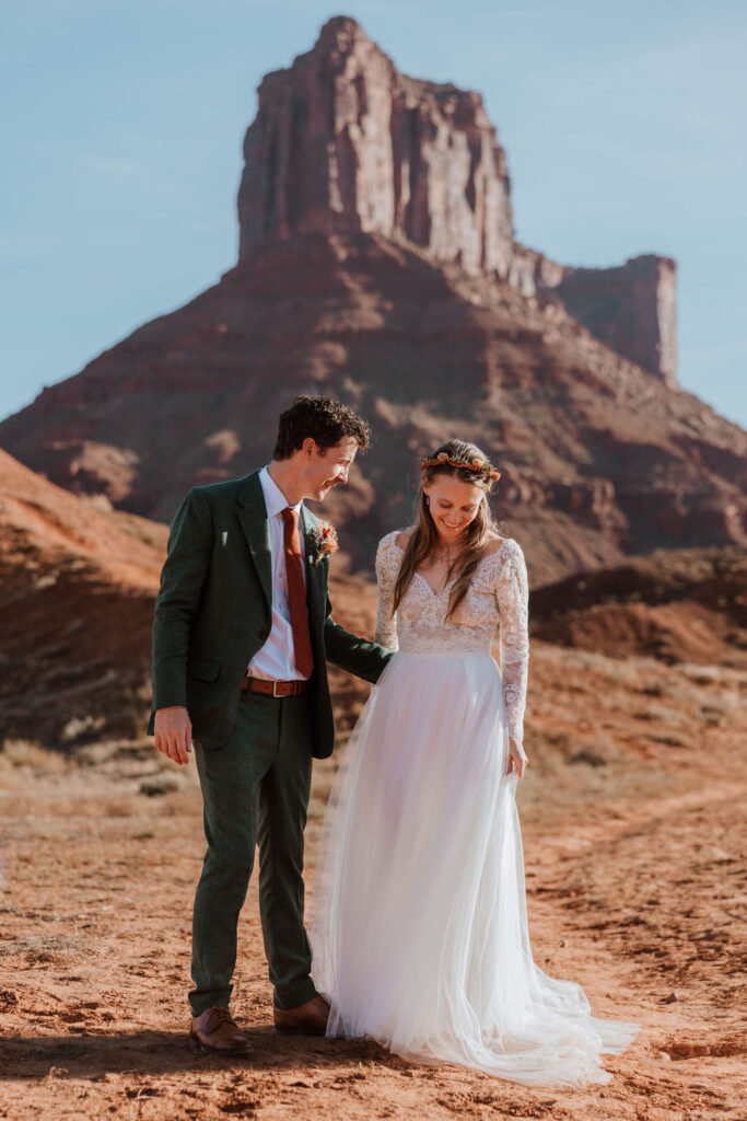 Couple walks hand in hand at Castle Valley Utah Elopement