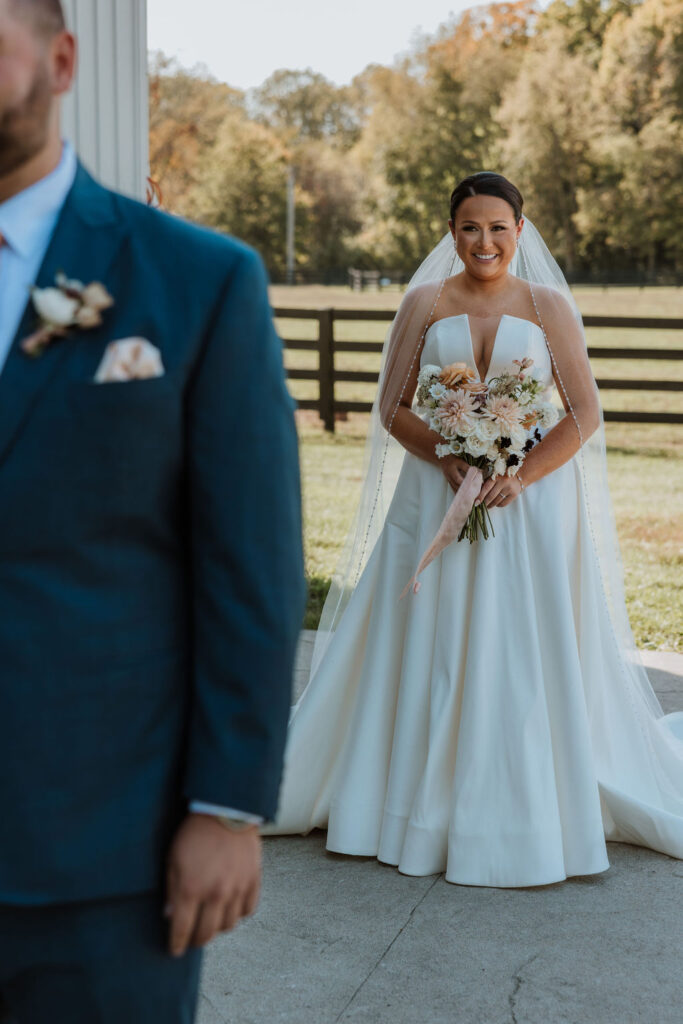 bride approaches groom during wedding first look