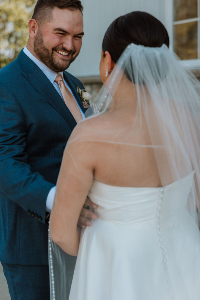 groom greets bride during wedding first look