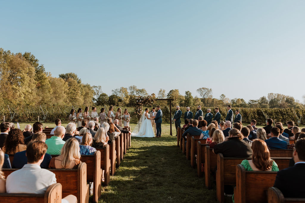 couple exchanges vows at farm wedding venue