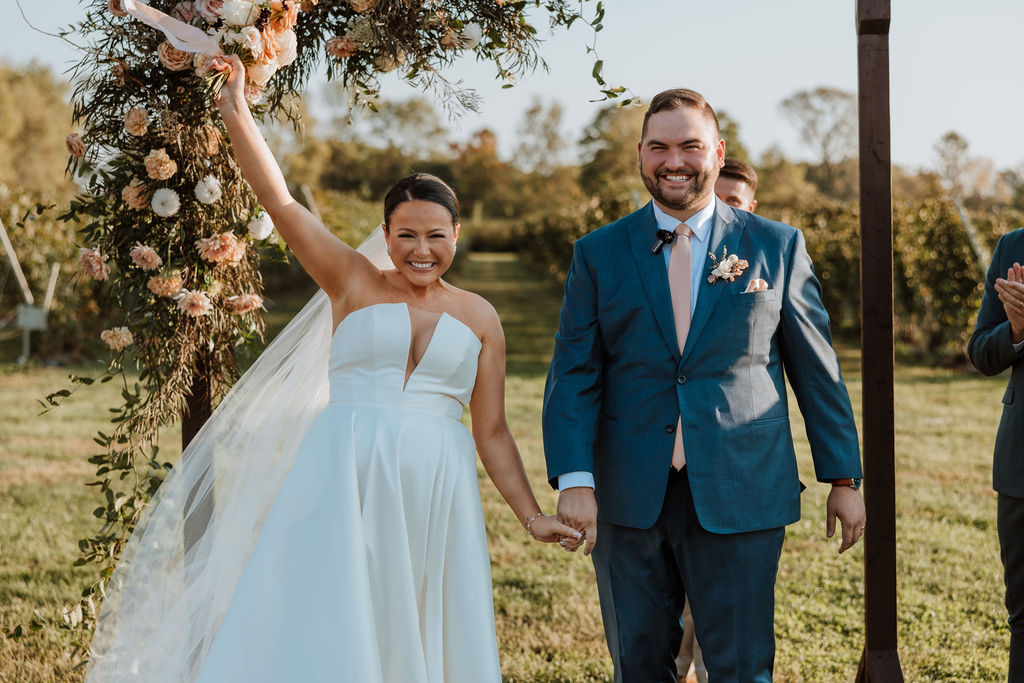couple cheers during wedding ceremony
