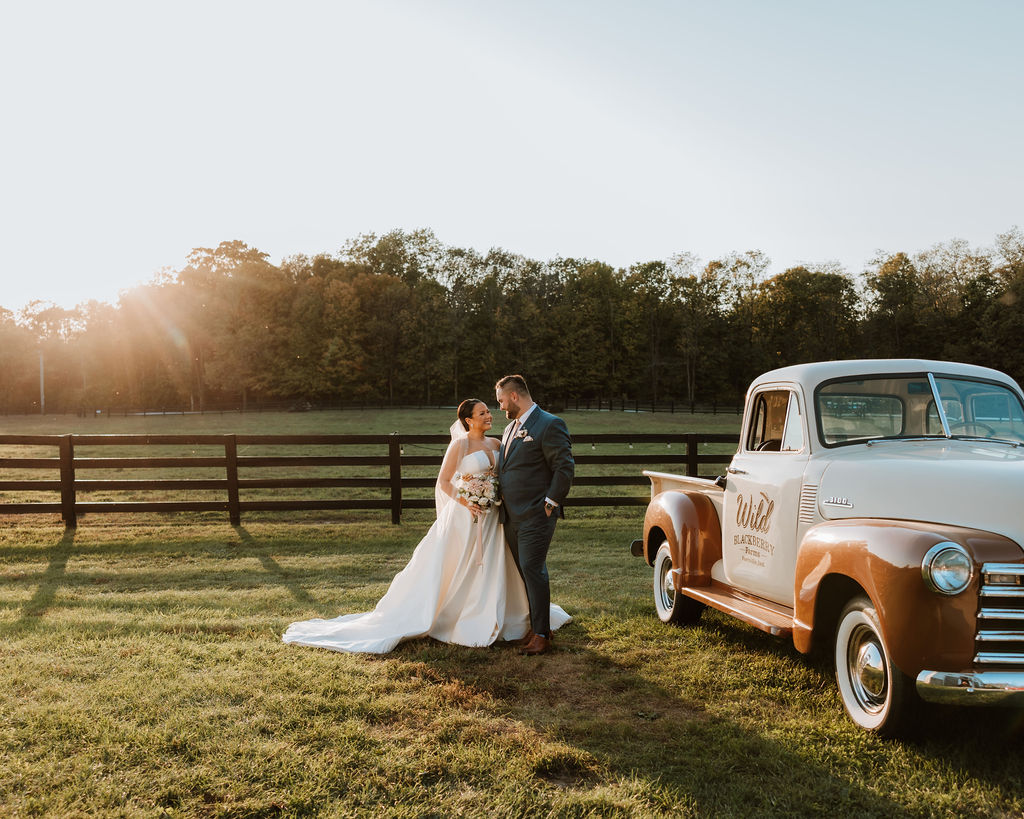 couple embraces in sunset at farm wedding venue