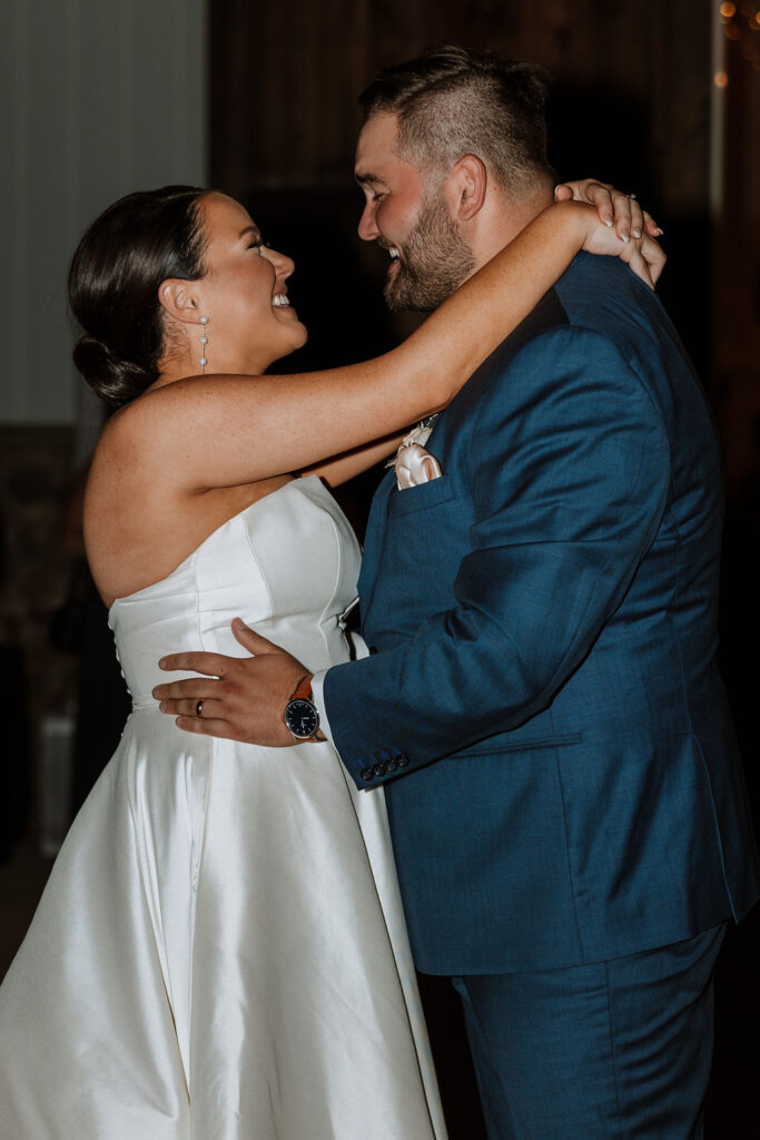 couple holds each other dancing at wedding reception