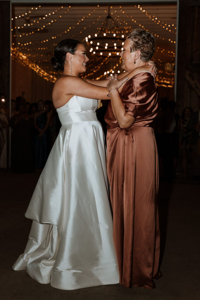 bride dances with mom at wedding reception