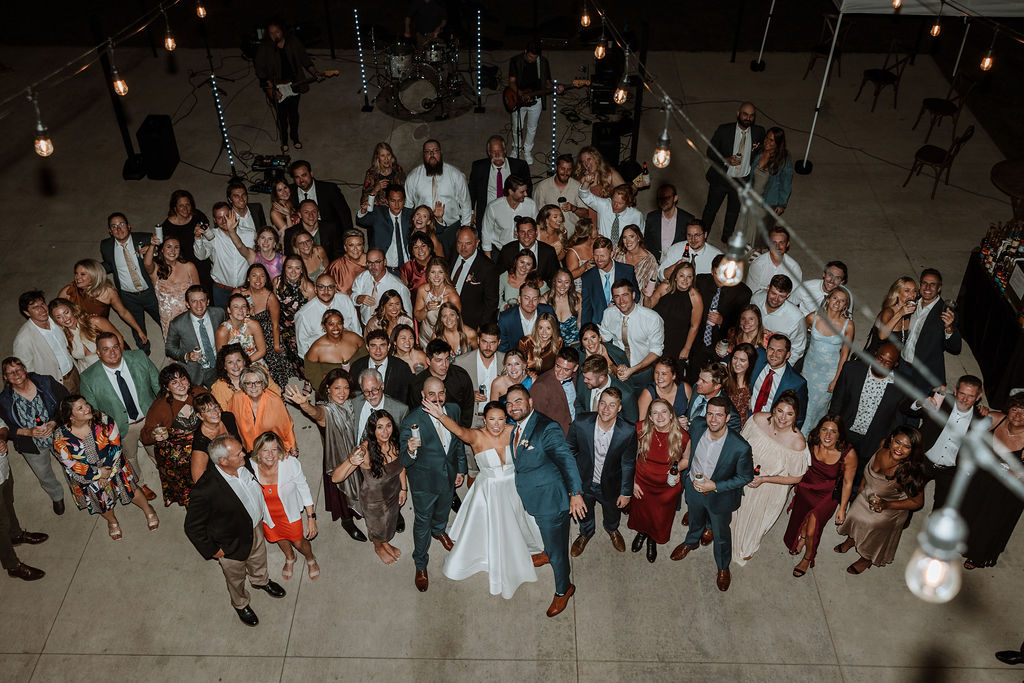 wedding guests post with bride and groom