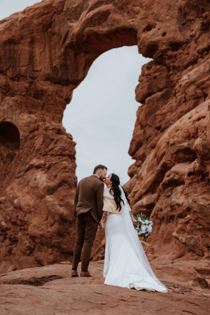 couple kisses at Arches National Park