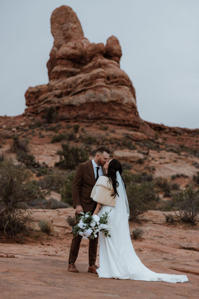 couple kisses at Arches National Park