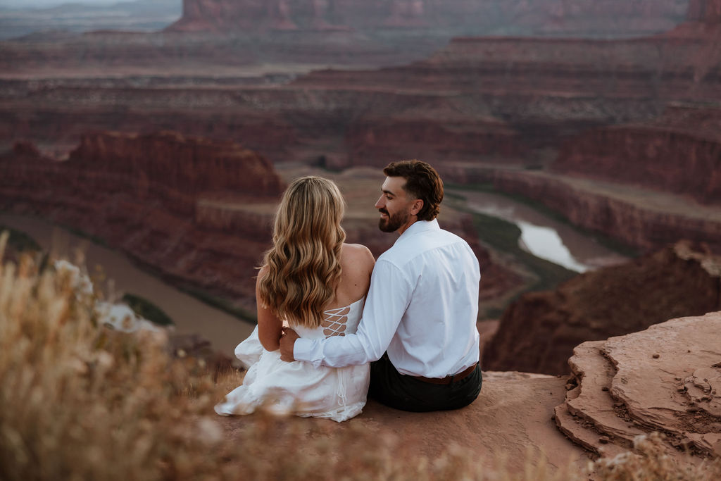 couple kisses on ledge at Dead Horse Point Moab