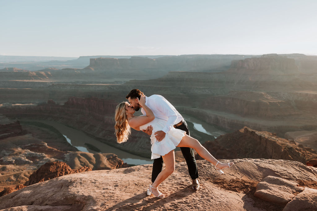 couple kisses at Dead Horse Point Moab engagement