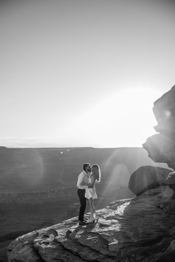 couple kisses at Dead Horse Point Moab engagement