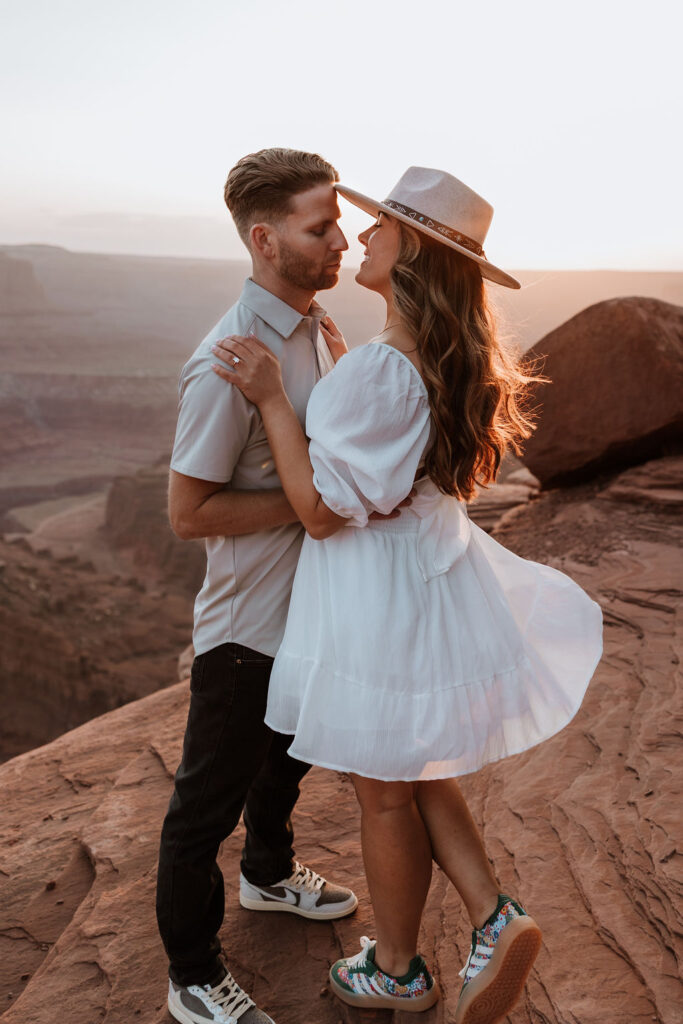 couple embraces on ledge at Dead Horse Point Moab