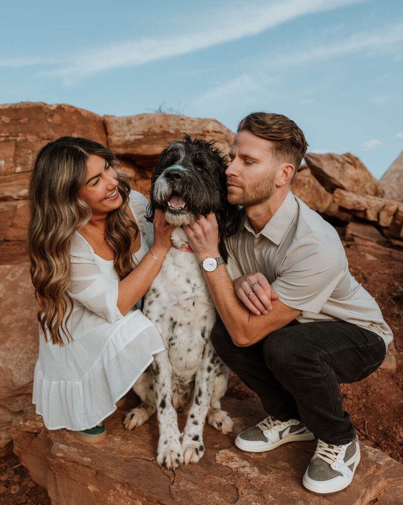 couple poses with dog at Dead Horse Point 