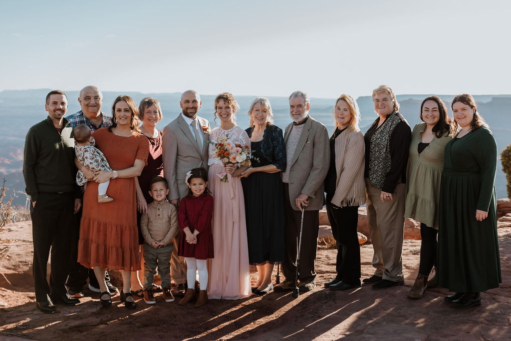 couple poses with guests at Dead Horse Point State Park