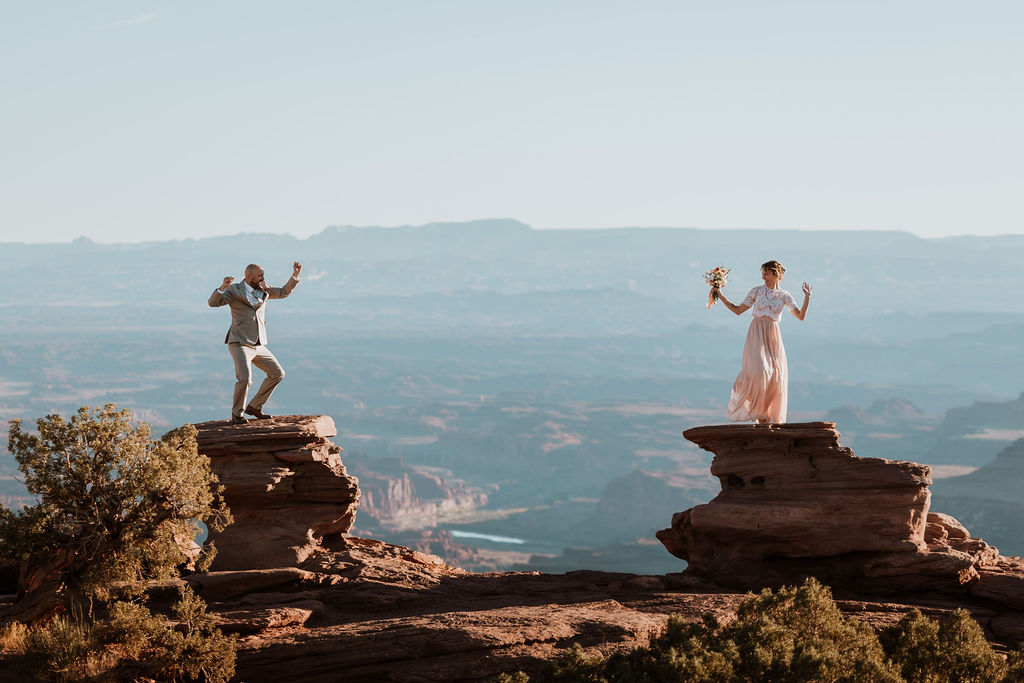 couple dances on cliff edge at Dead Horse Point State Park
