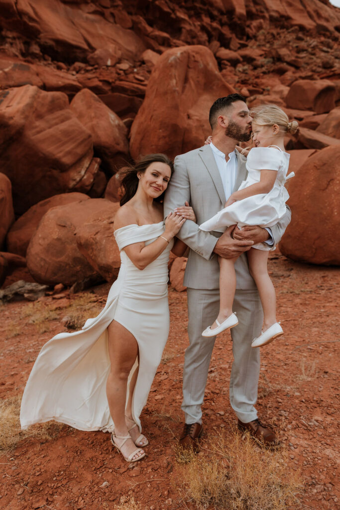 family portrait in front of rocky landscape in moab