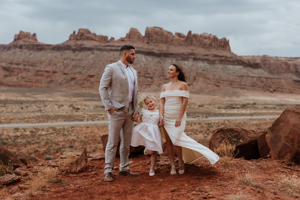 family portrait in front of rocky landscape in moab