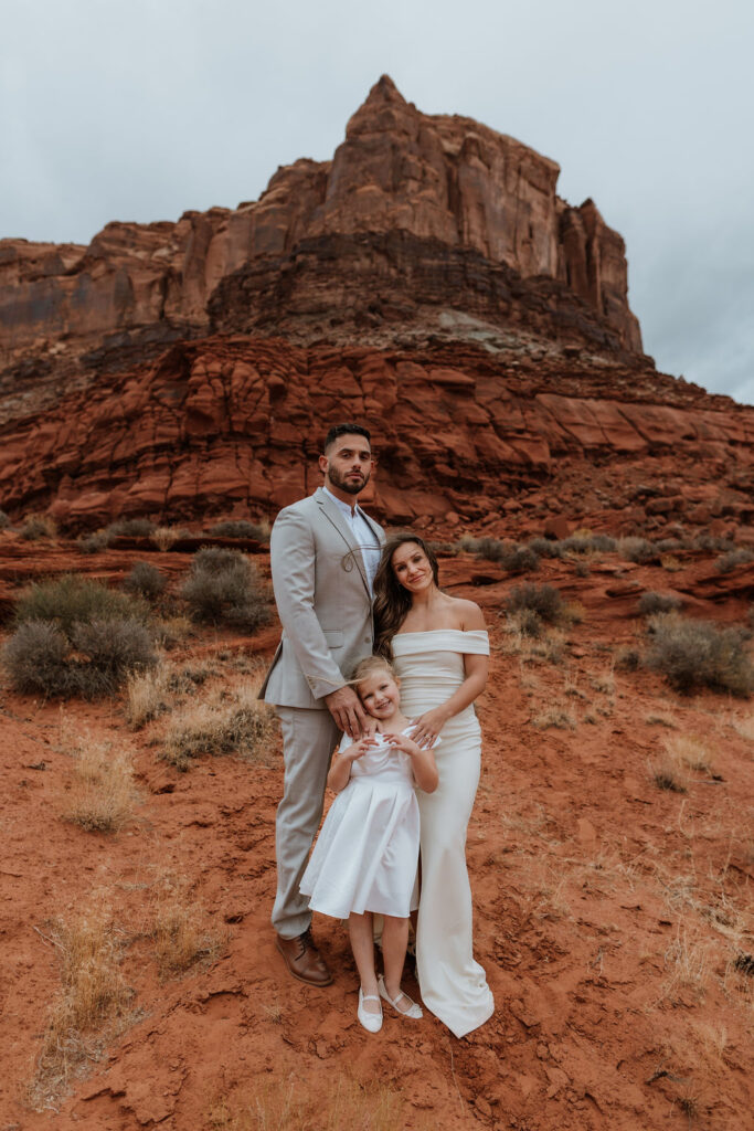 family portrait in front of rocky landscape in moab