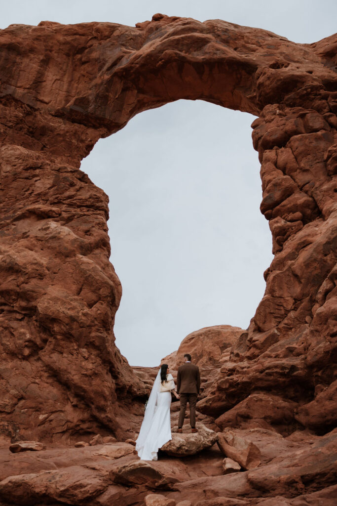 Couple stands at Moab arches for portraits