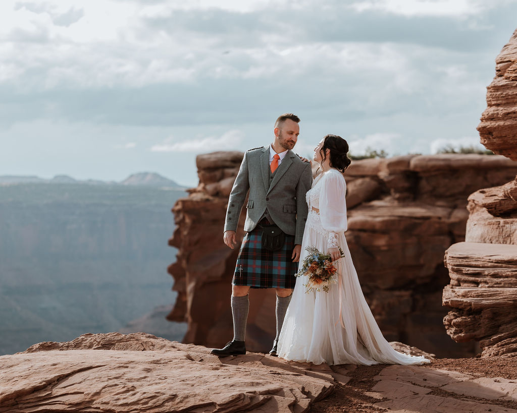 couple posing on Moab's red rock landscape
