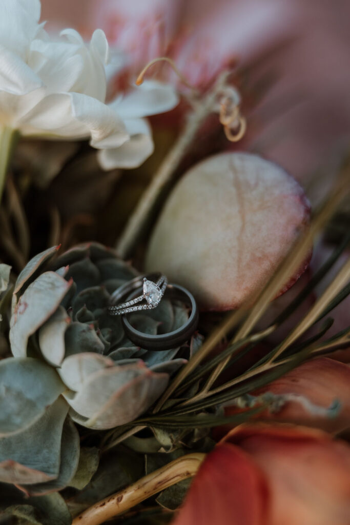 rings sitting in flower bouquet