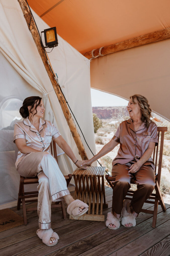 bride and mother talking before under canvas moab wedding