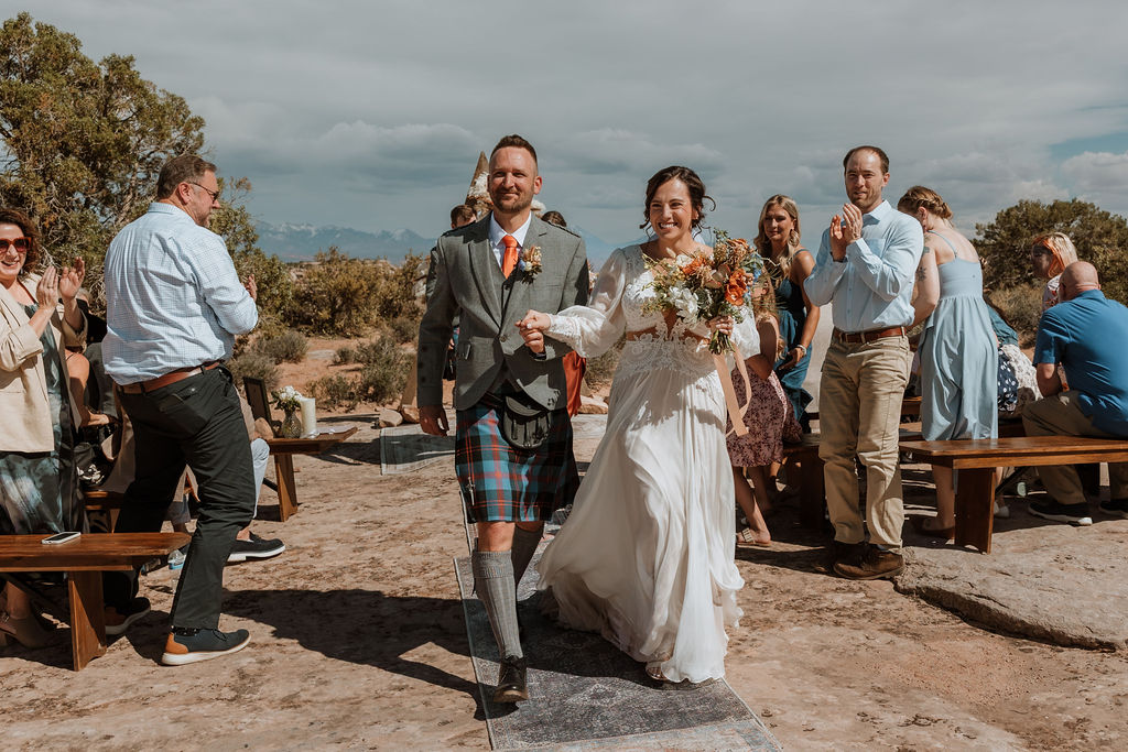 bride and groom celebrating after ceremony at under canvas Moab venue