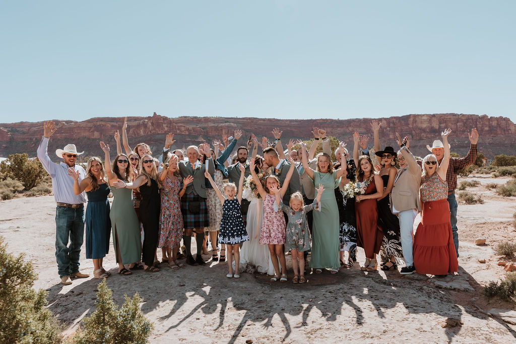 entire family poses at under canvas moab wedding