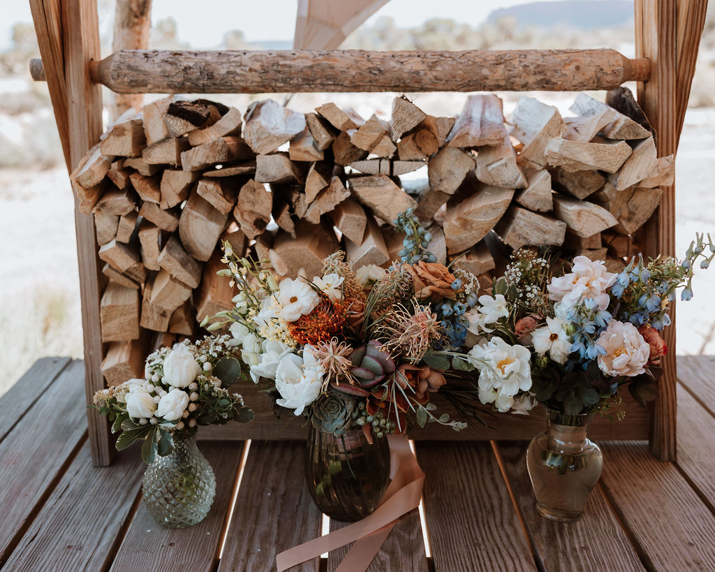 floral centerpieces for under canvas moab wedding