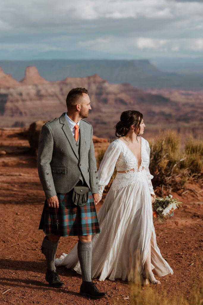 couple walking along red rocky path
