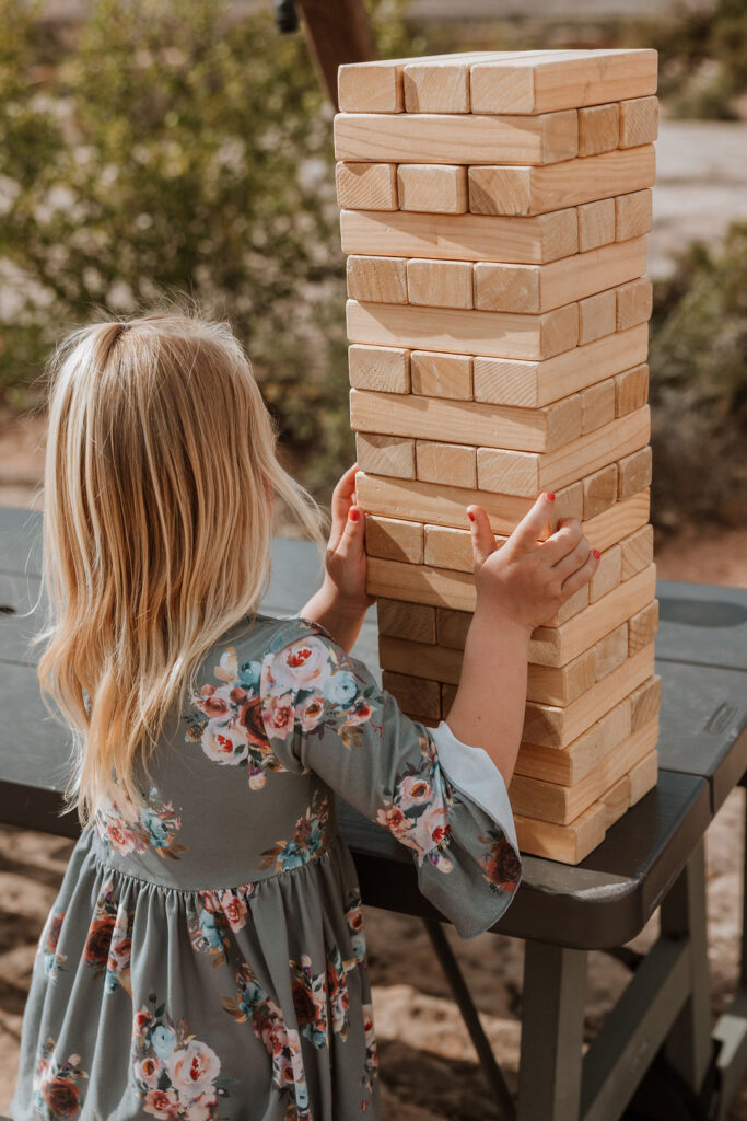 little girl playing Jenga