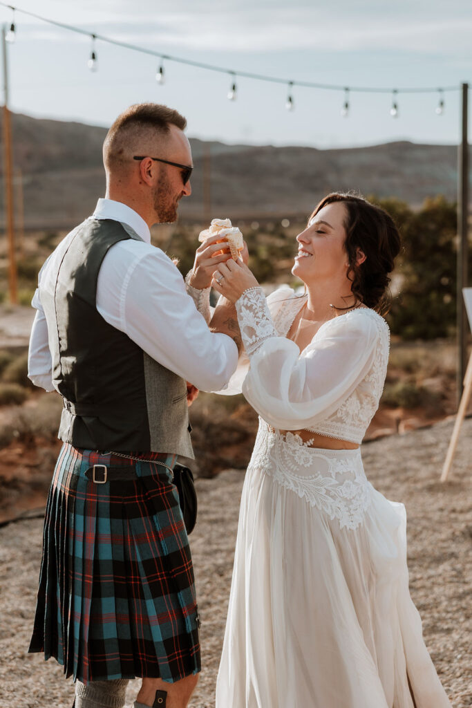 couple exchanging wedding cupcakes during reception 