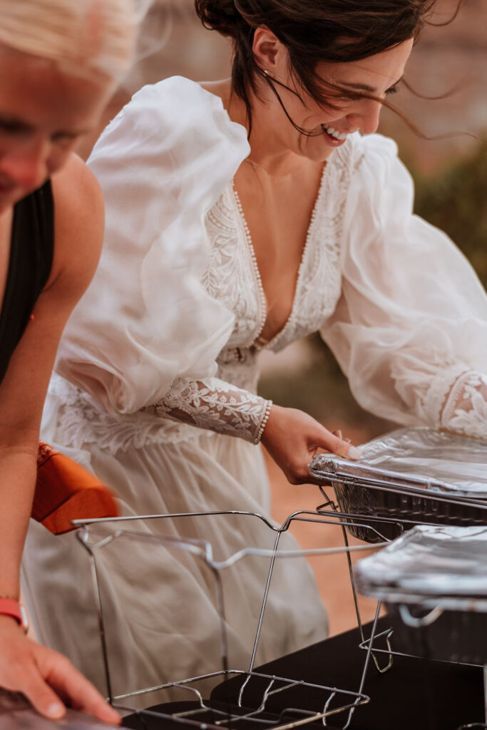women covering food from the wind