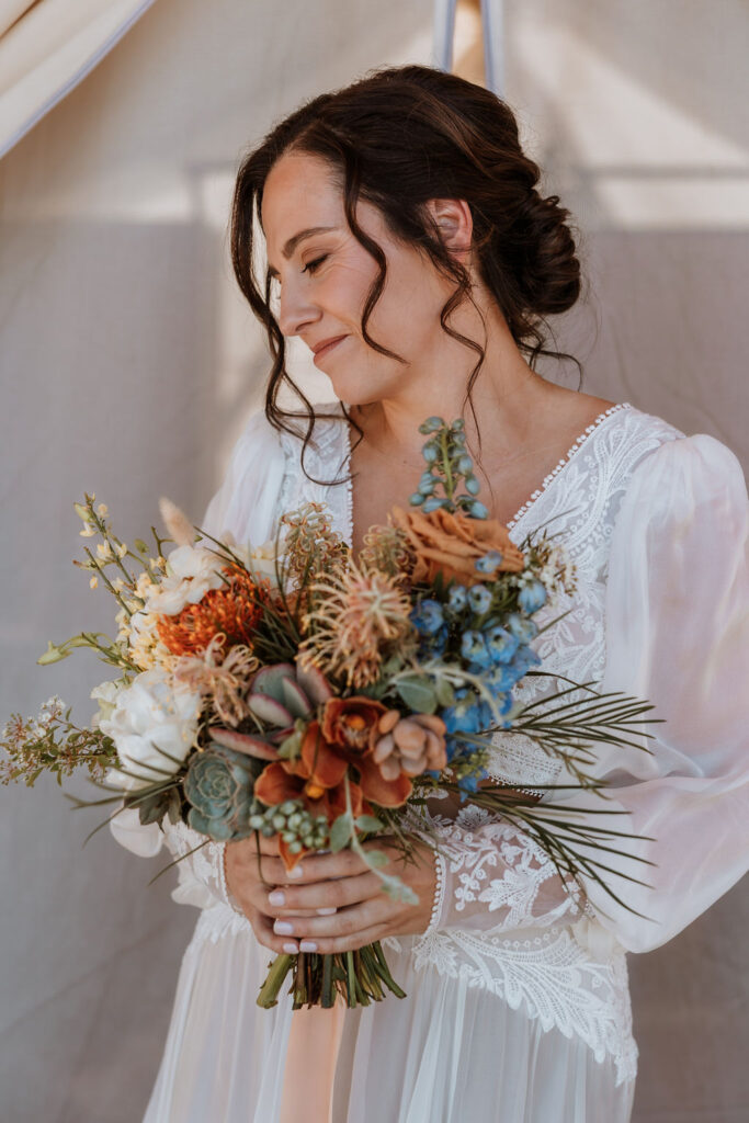 bride poses with wedding bouquet