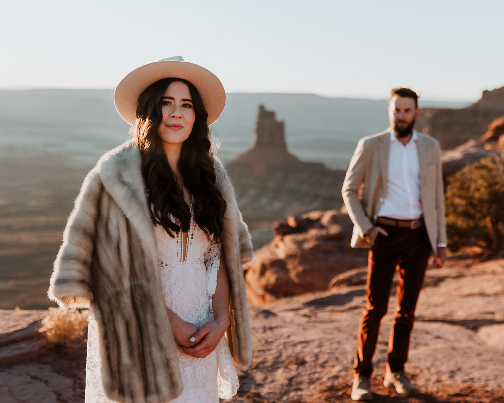 couple posing on canyon overlook in moab