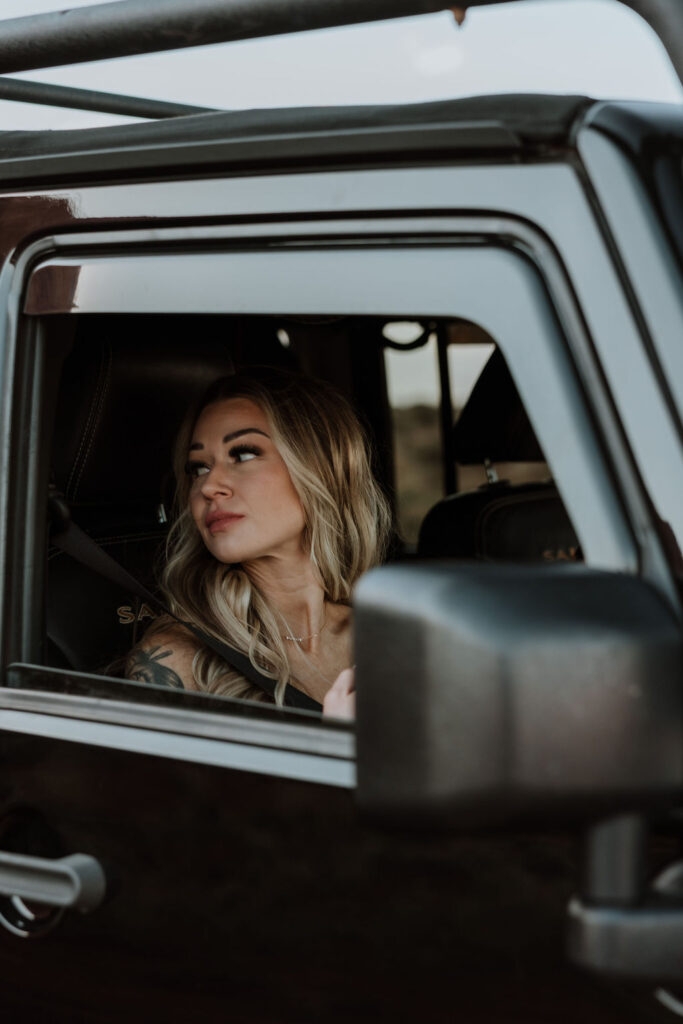 bride looking out the window of jeep