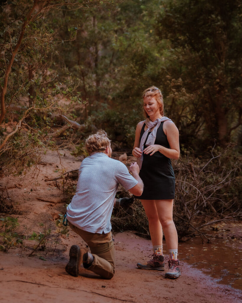 man proposes to woman during rappelling adventure