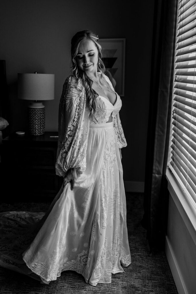 bride admiring her dress after putting it on
