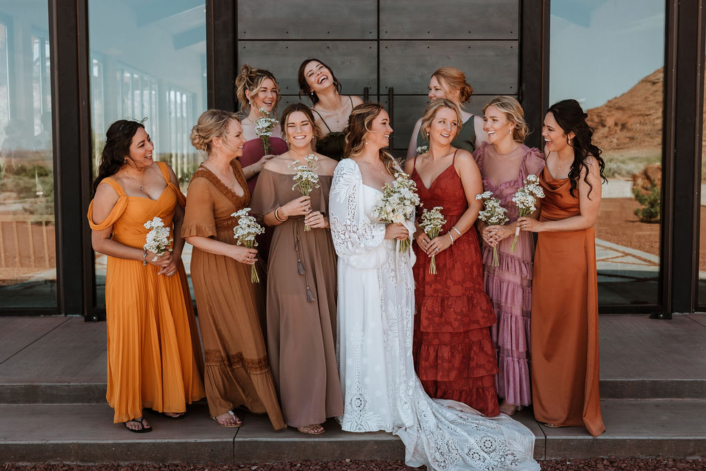 bridal party pose in in front of Red Earth venue