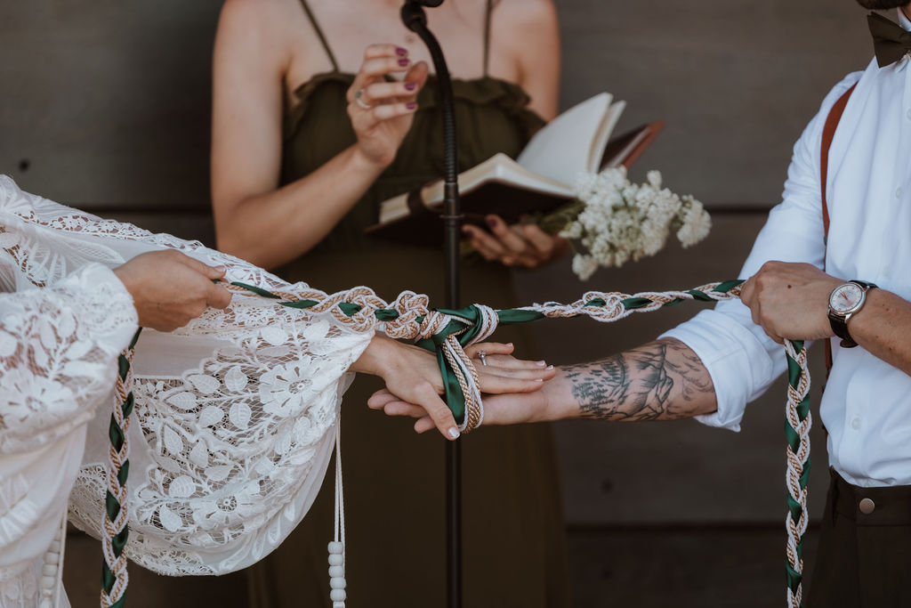couple participate in handfasting ceremony during wedding ceremony