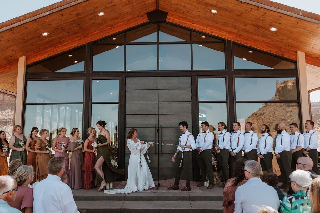 couple participate in handfasting ceremony during wedding ceremony