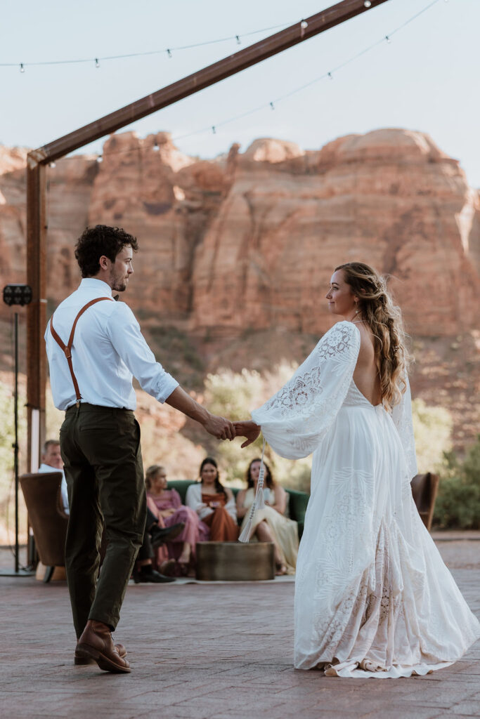 couple holding hands while doing their first dance